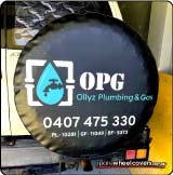 Spare tyre cover showing business advertising for Ollyz Plumbing and Gas on a Toyota Prado